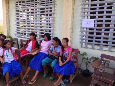 Schoolgirls wait to be seen outside a clinic.